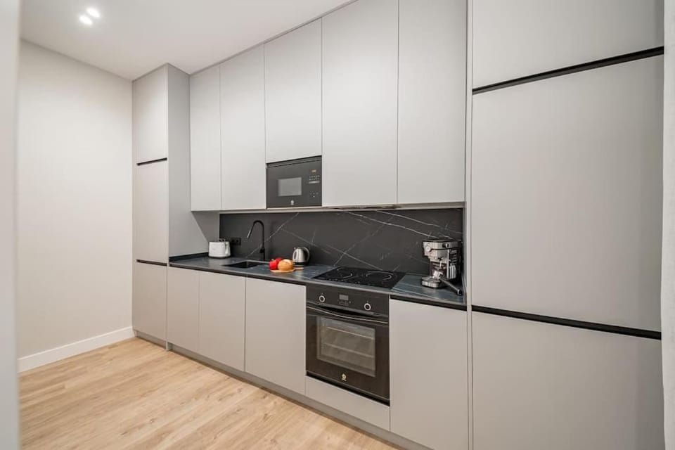 Kitchen or kitchenette, dishwasher, oven, stove