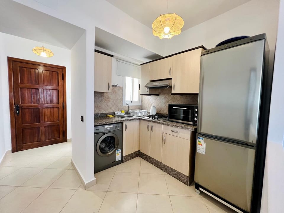 Kitchen or kitchenette, oven, stove, washing machine