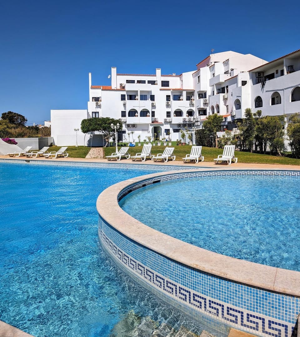 Property building, Nearby landmark, Pool view, Swimming pool, sunbed