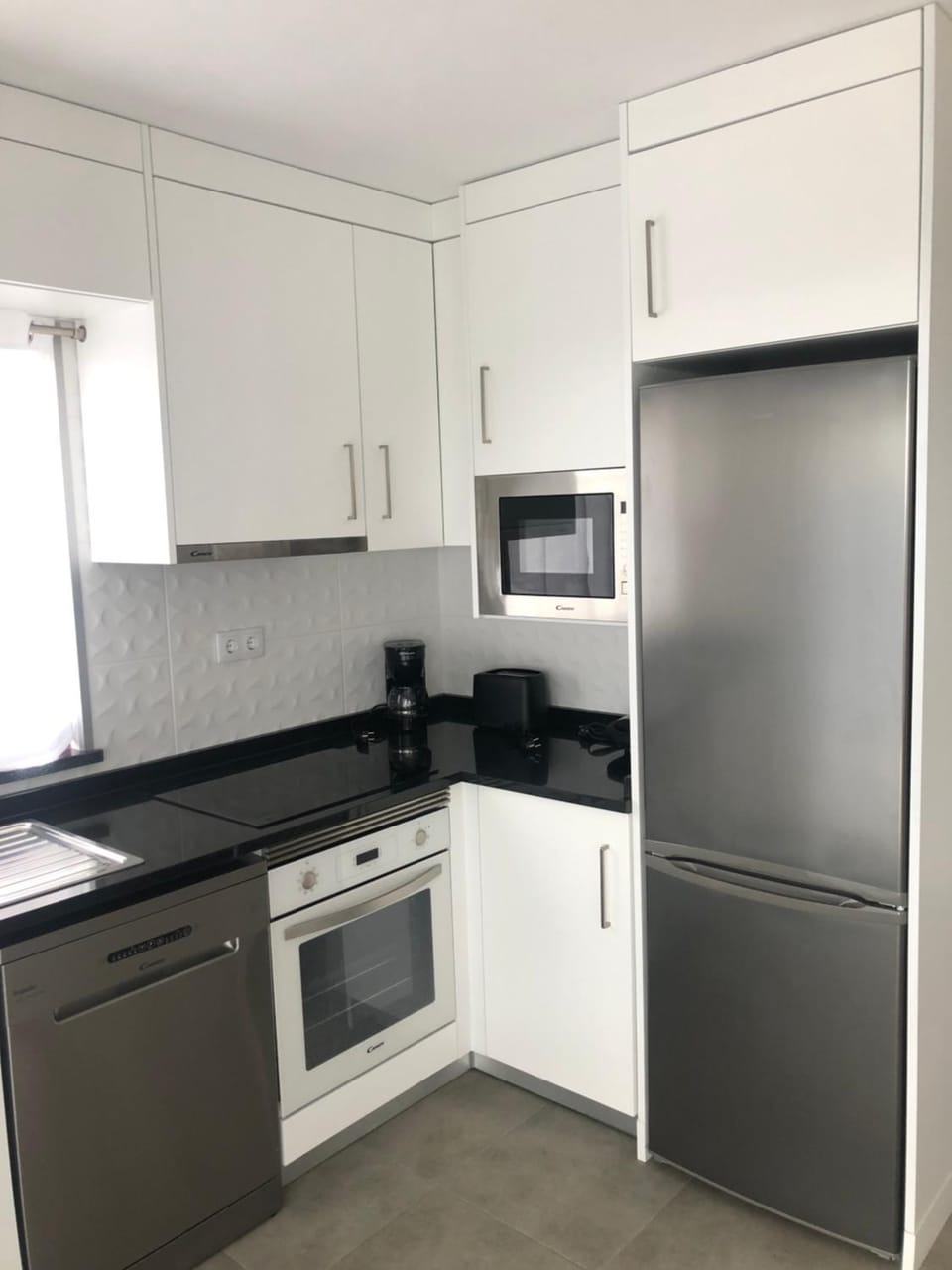 Kitchen or kitchenette, dishwasher, oven, stove