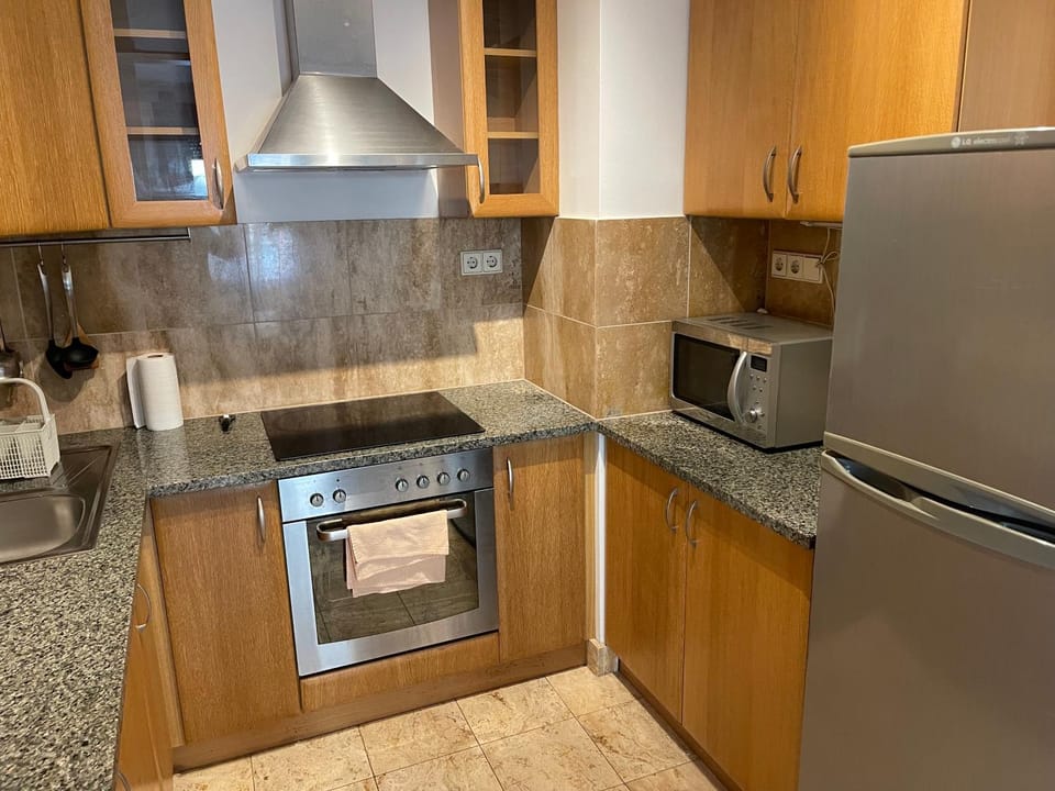 Kitchen or kitchenette, dishwasher, oven, stove