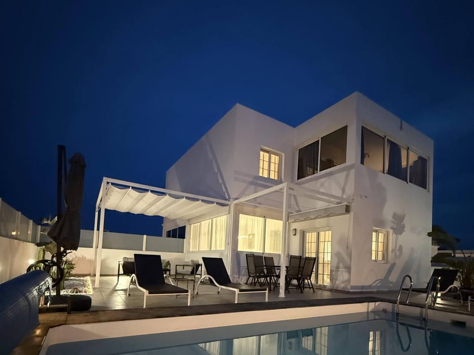 Property building, Patio, Night, Swimming pool, sunbed