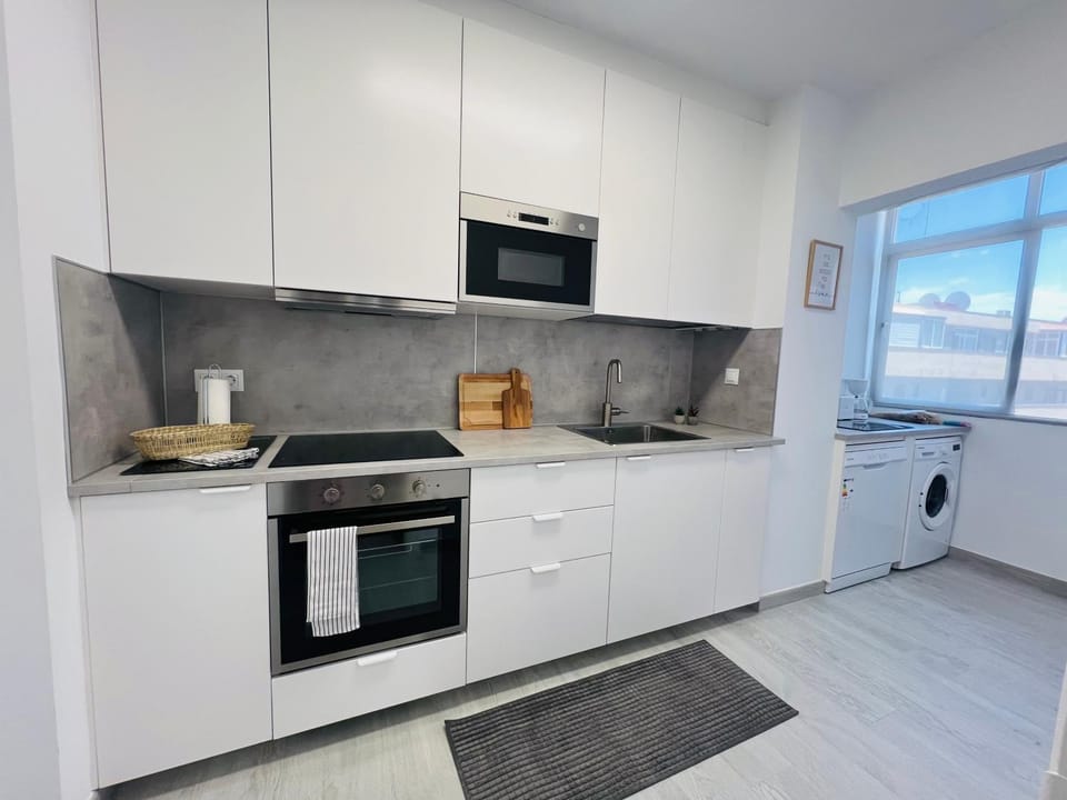 Kitchen or kitchenette, dishwasher, microwave, oven, stove, washing machine