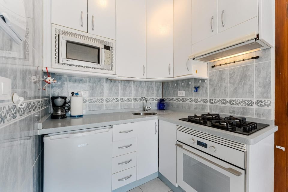 Kitchen or kitchenette, microwave, oven, stove, toaster