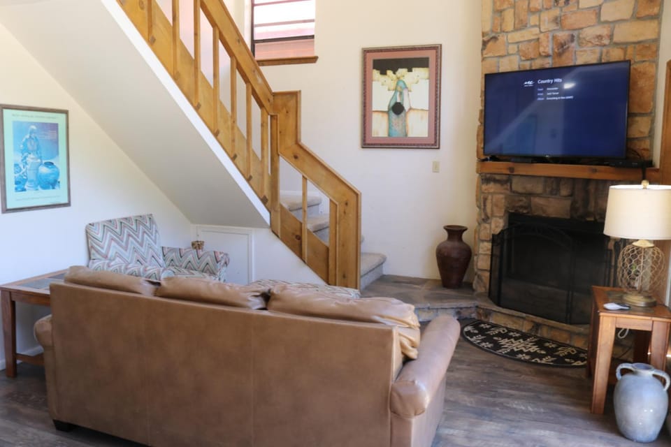 Day, TV and multimedia, Living room, Seating area, fireplace, furniture, air conditioner