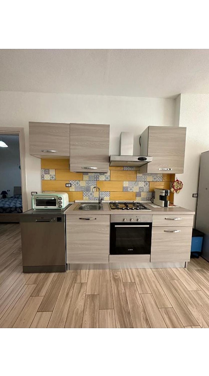 Kitchen or kitchenette, dishwasher, oven, stove