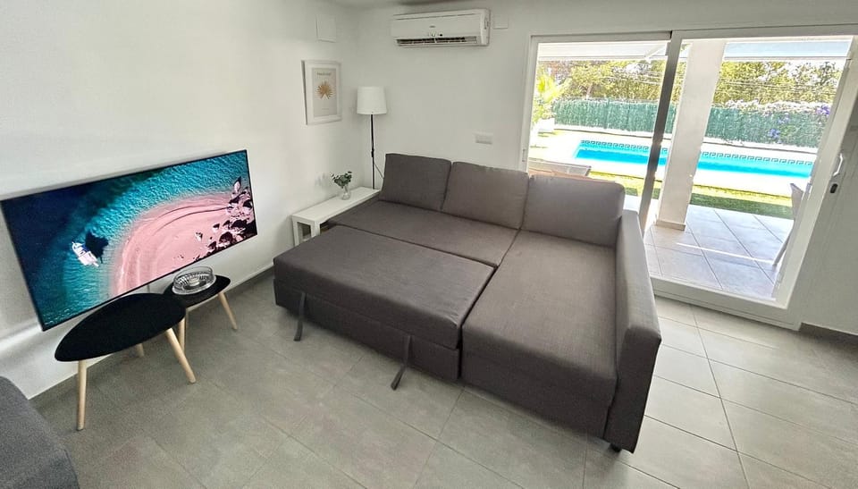 TV and multimedia, Living room, Seating area, Pool view, air conditioner