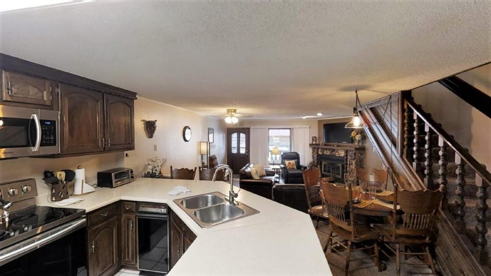 Kitchen or kitchenette, Living room, Seating area, Dining area, fireplace, furniture, microwave, kitchen