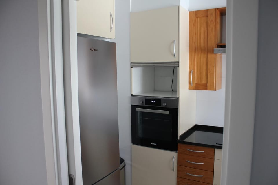 Kitchen or kitchenette, dishwasher, oven, stove, washing machine