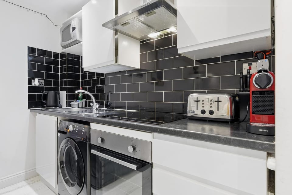 Kitchen or kitchenette, stove, toaster, washing machine