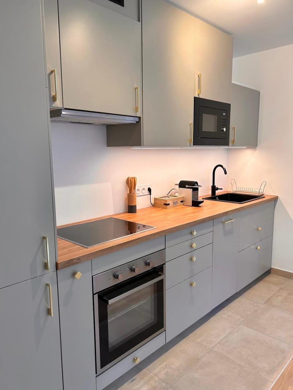 Kitchen or kitchenette, dishwasher, microwave, oven, stove