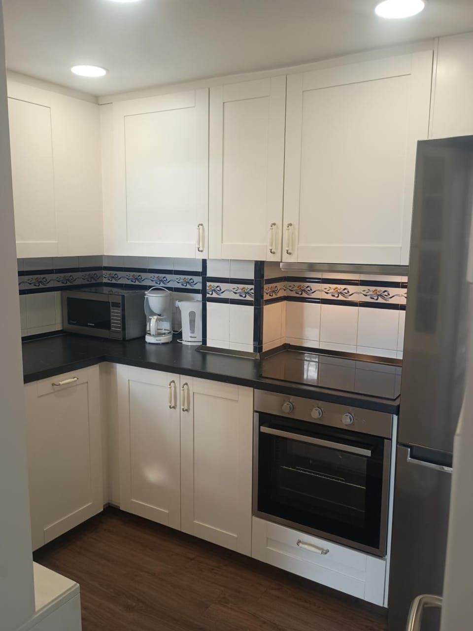 Kitchen or kitchenette, dishwasher, oven, stove