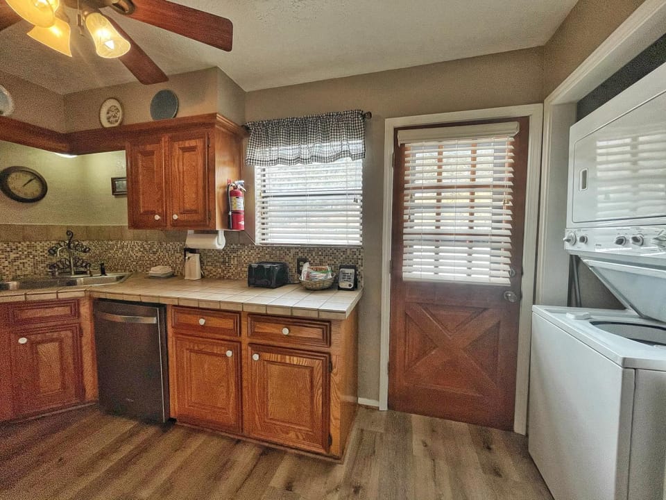 Kitchen or kitchenette, dishwasher, furniture, microwave, toaster, washing machine, dryer
