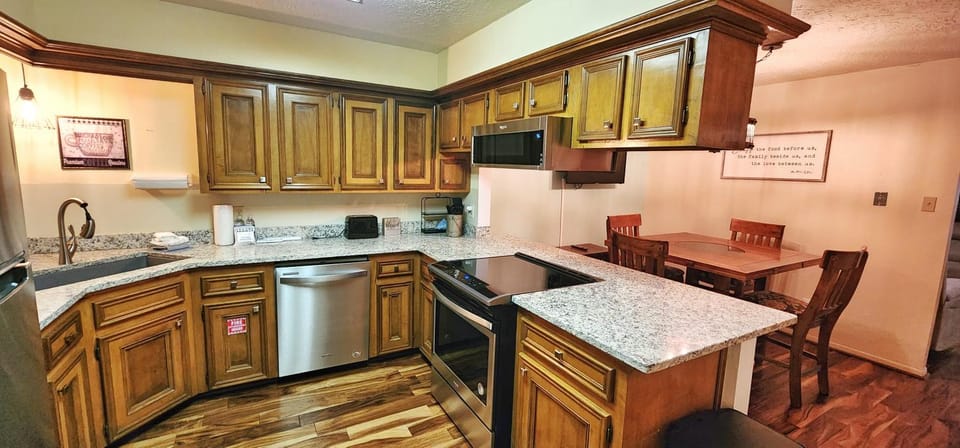 Kitchen or kitchenette, Dining area, dishwasher, furniture, microwave, oven, stove, kitchen