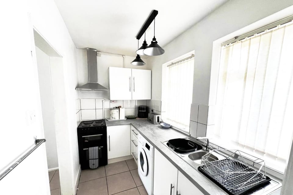 Kitchen or kitchenette, oven, stove, toaster, washing machine