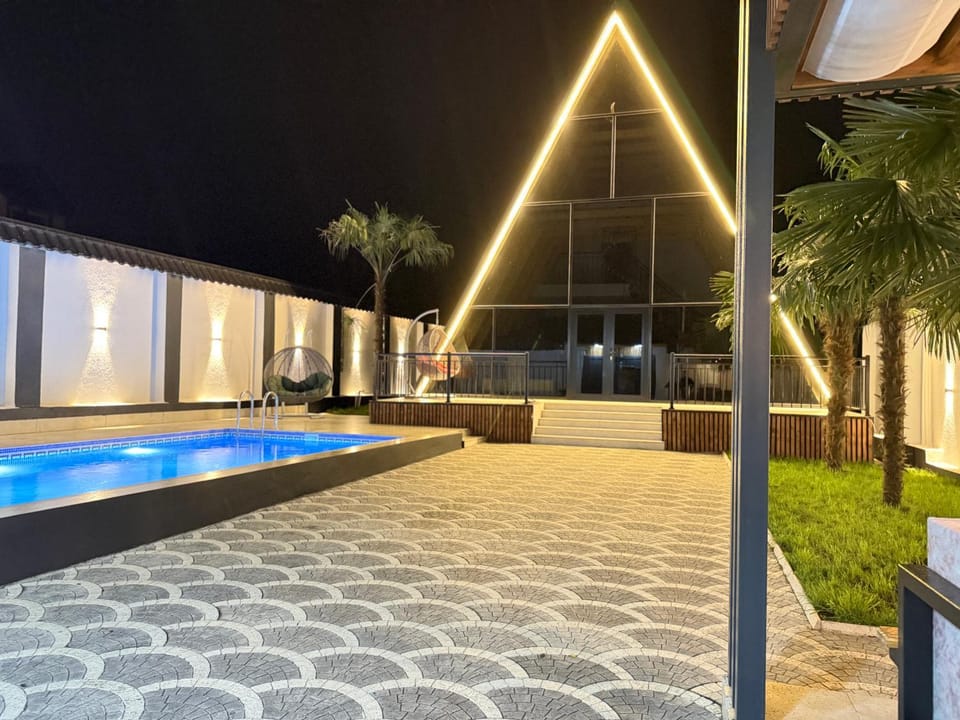 Property building, Patio, Night, Natural landscape, Pool view, Swimming pool, sunbed