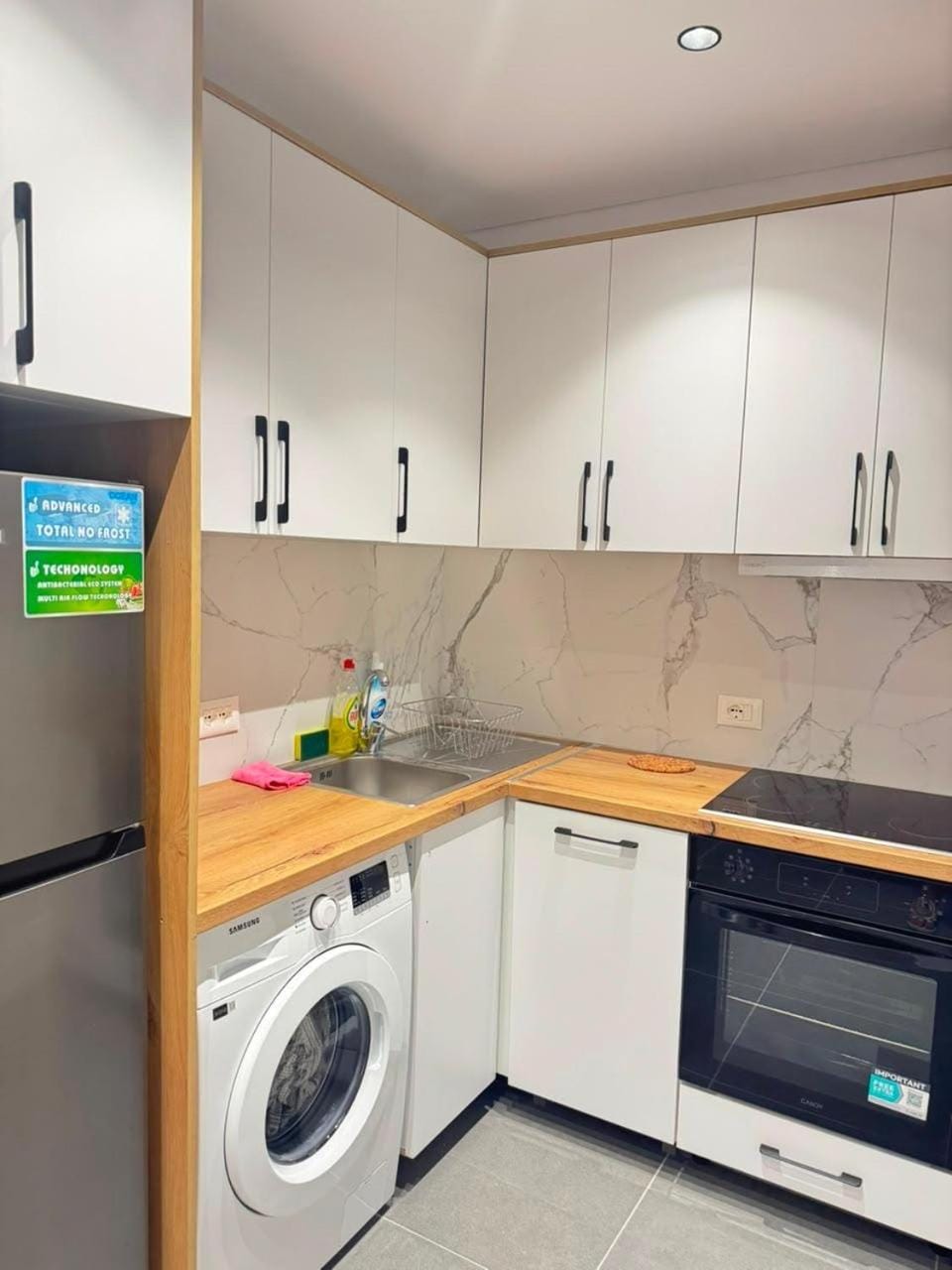Kitchen or kitchenette, dishwasher, oven, stove, washing machine