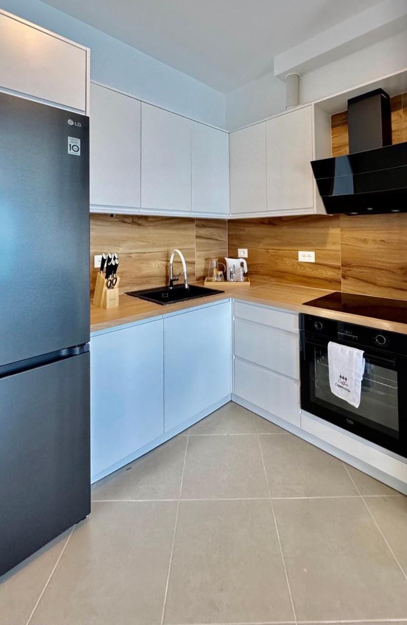 Kitchen or kitchenette, dishwasher, oven, stove