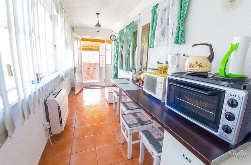 Kitchen or kitchenette, microwave, oven, stove, air conditioner