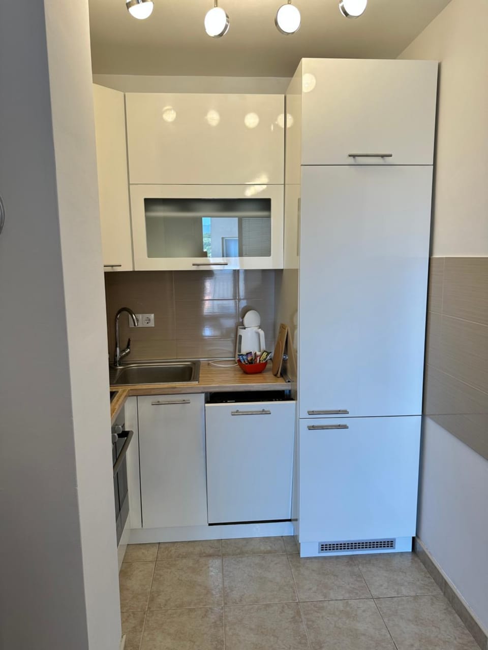 Kitchen or kitchenette, dishwasher, oven, stove