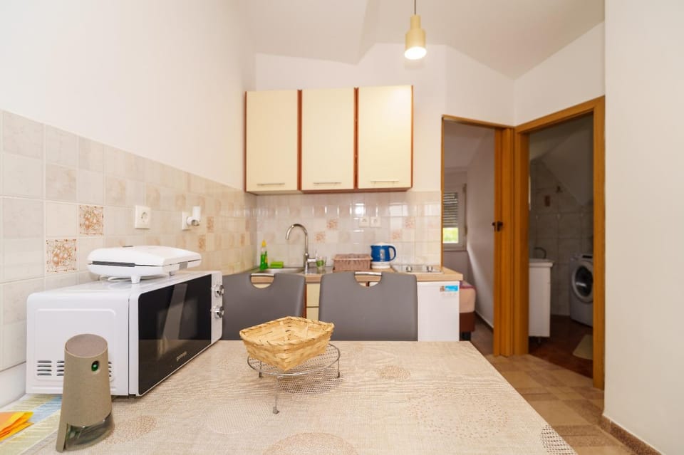 Kitchen or kitchenette, microwave, stove, toaster