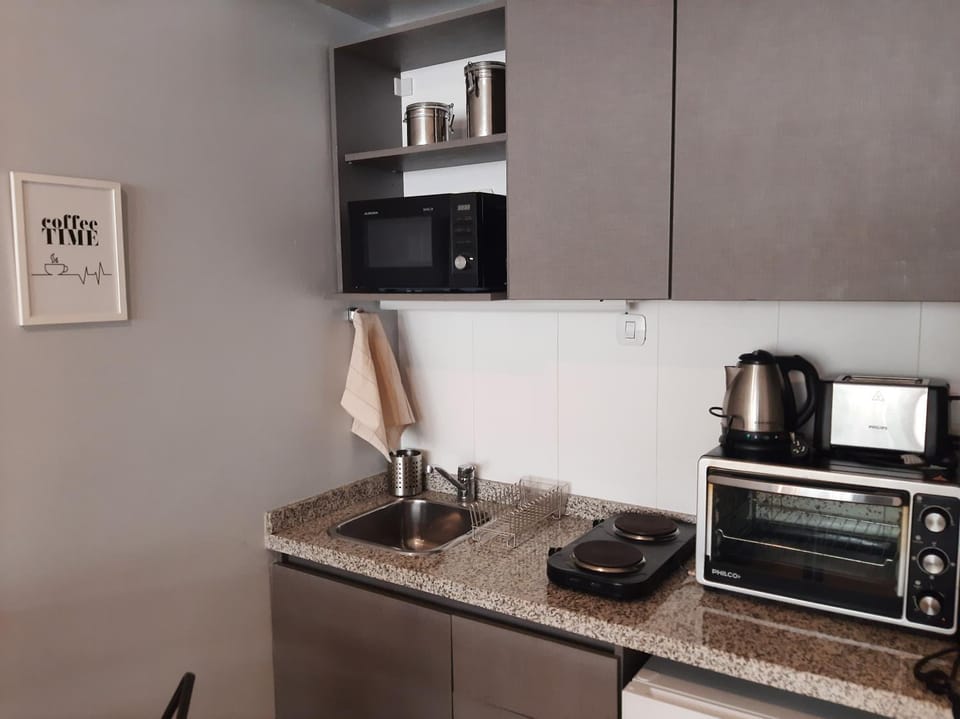 Kitchen or kitchenette, microwave, oven, stove, toaster