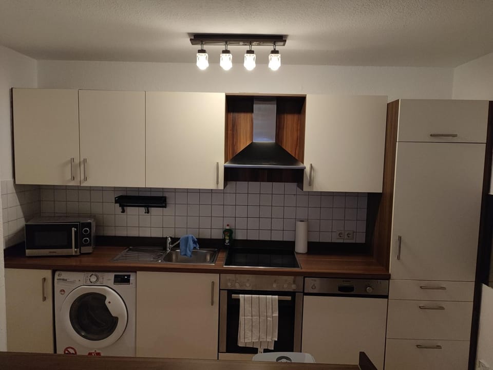 Kitchen or kitchenette, dishwasher, oven, stove, washing machine