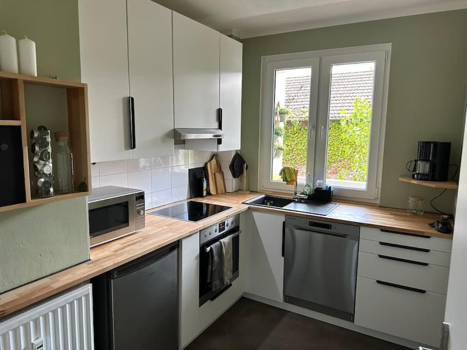 Kitchen or kitchenette, dishwasher, oven, stove
