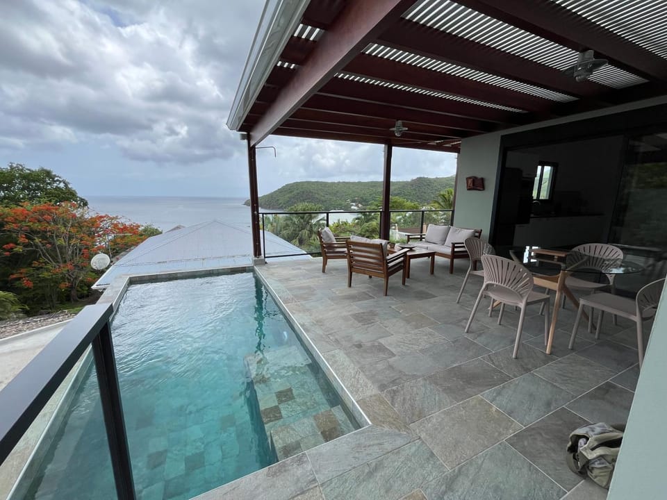 Patio, Natural landscape, View (from property/room), Living room, Dining area, Sea view, Swimming pool
