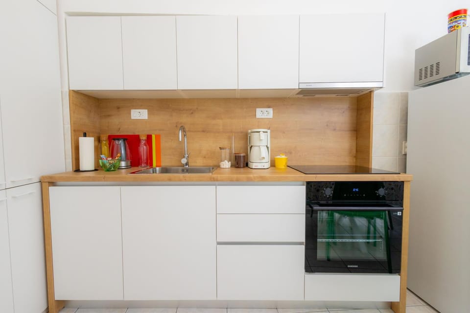 Kitchen or kitchenette, dishwasher, oven, stove