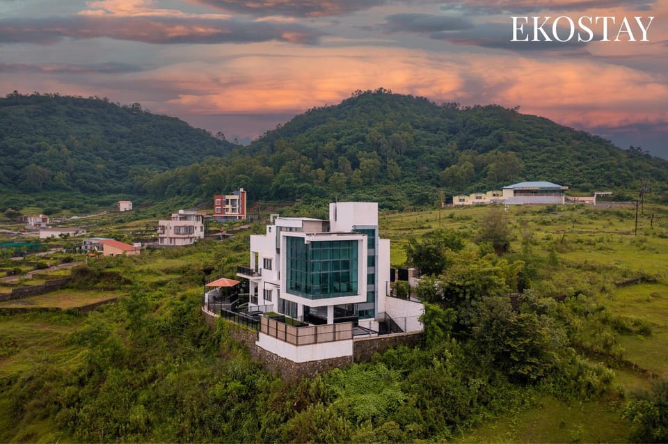 Property building, Nearby landmark, Day, Natural landscape, Bird's eye view, Text overlay, Mountain view