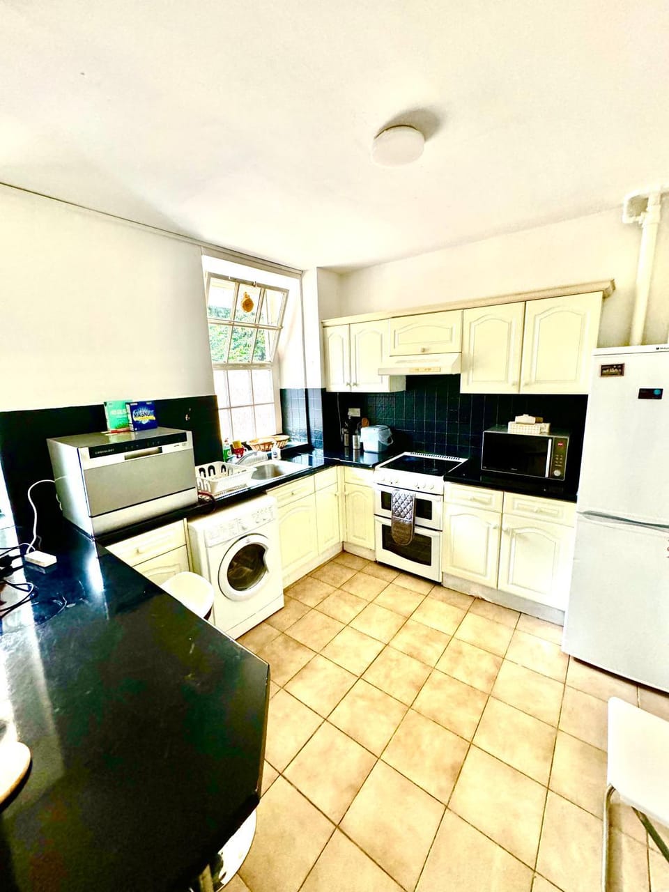Kitchen or kitchenette, dishwasher, oven, stove, toaster, washing machine
