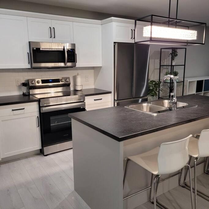Kitchen or kitchenette, dishwasher, oven, stove, toaster