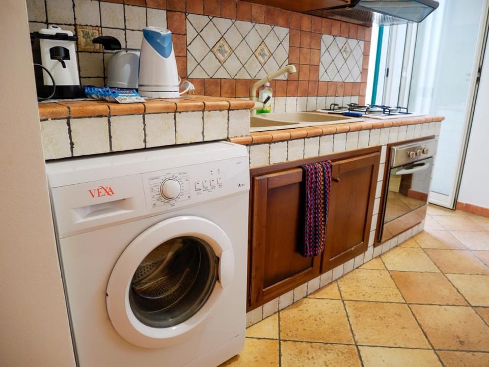 Kitchen or kitchenette, stove, washing machine