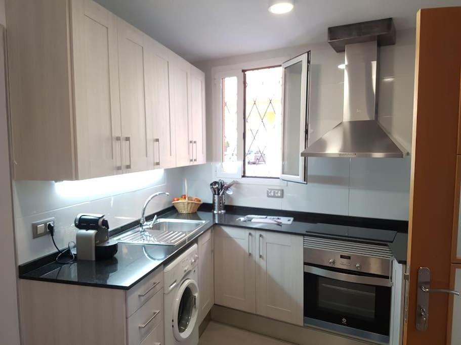 Kitchen or kitchenette, stove, toaster, washing machine