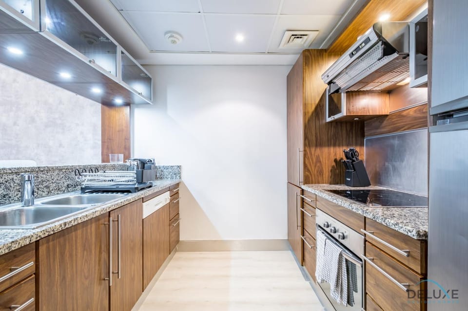 Kitchen or kitchenette, dishwasher, oven, stove