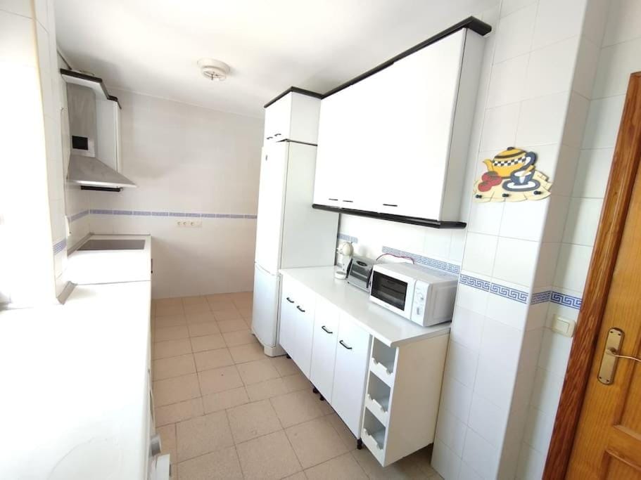 Kitchen or kitchenette, dishwasher, oven, stove