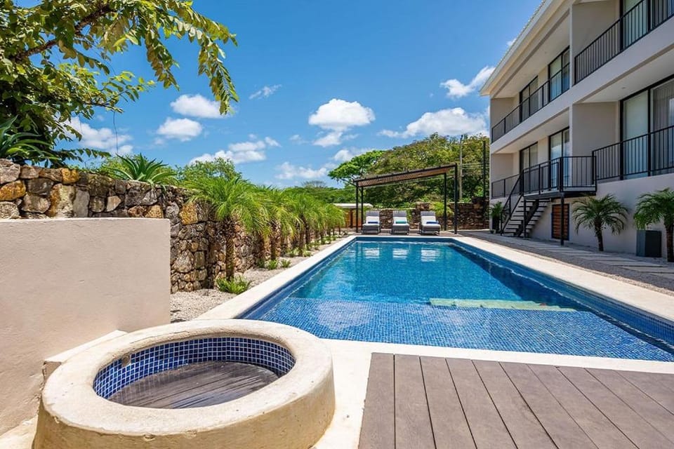 Property building, Day, Pool view, Swimming pool, sunbed