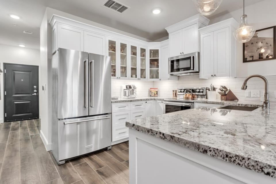 Kitchen or kitchenette, dishwasher, oven, stove
