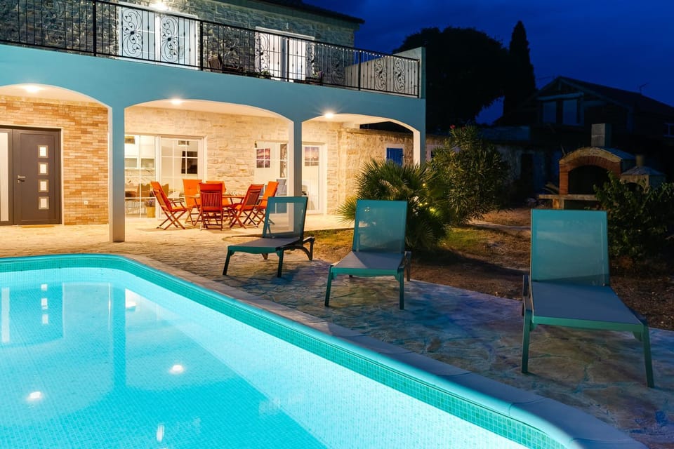 Property building, Patio, Night, Swimming pool, sunbed