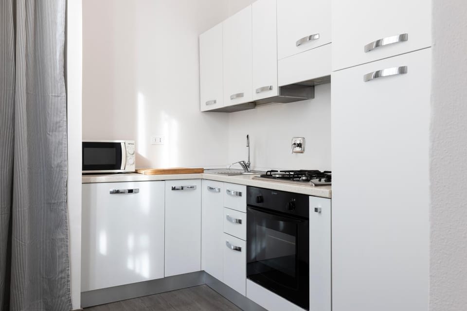 Kitchen or kitchenette, dishwasher, oven, stove