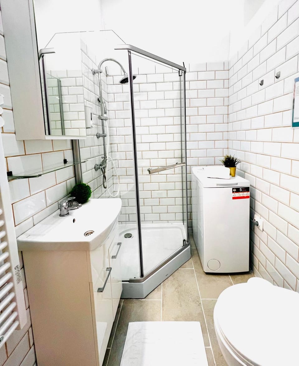 Shower, Toilet, Bathroom, hair dryier, towels, washing machine