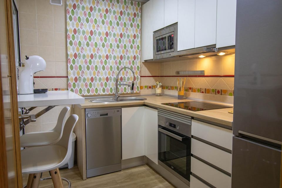 Kitchen or kitchenette, dishwasher, oven, stove