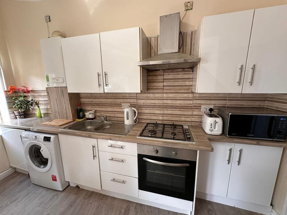 Kitchen or kitchenette, microwave, oven, stove, toaster, washing machine, kitchen, kitchen