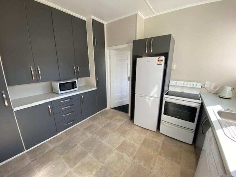 Kitchen or kitchenette, dishwasher, microwave, oven, stove, toaster
