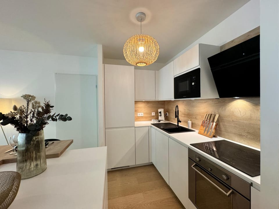 Kitchen or kitchenette, dishwasher, oven, stove