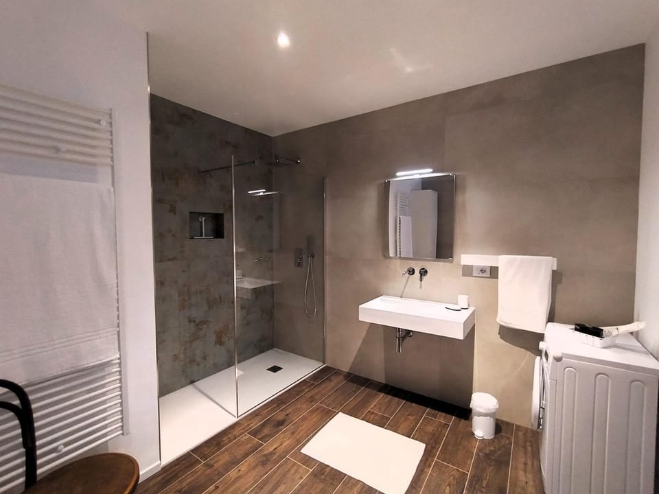 Shower, Bathroom, hair dryier, towels, washing machine