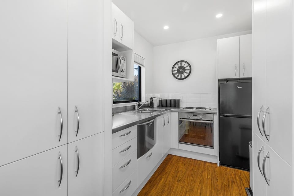 Kitchen or kitchenette, dishwasher, microwave, oven, stove