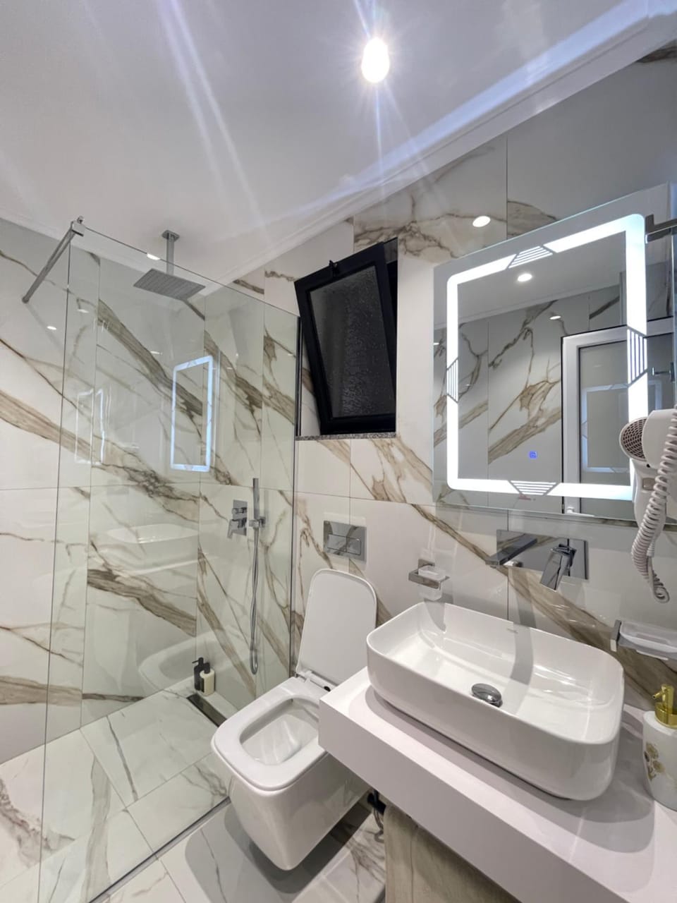 Shower, Toilet, hair dryier, towels