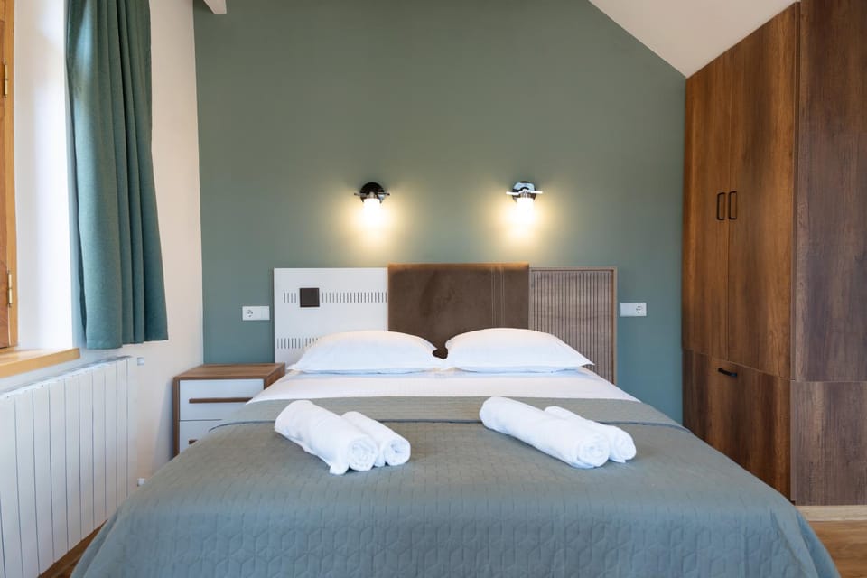 Bed, towels, wardrobe